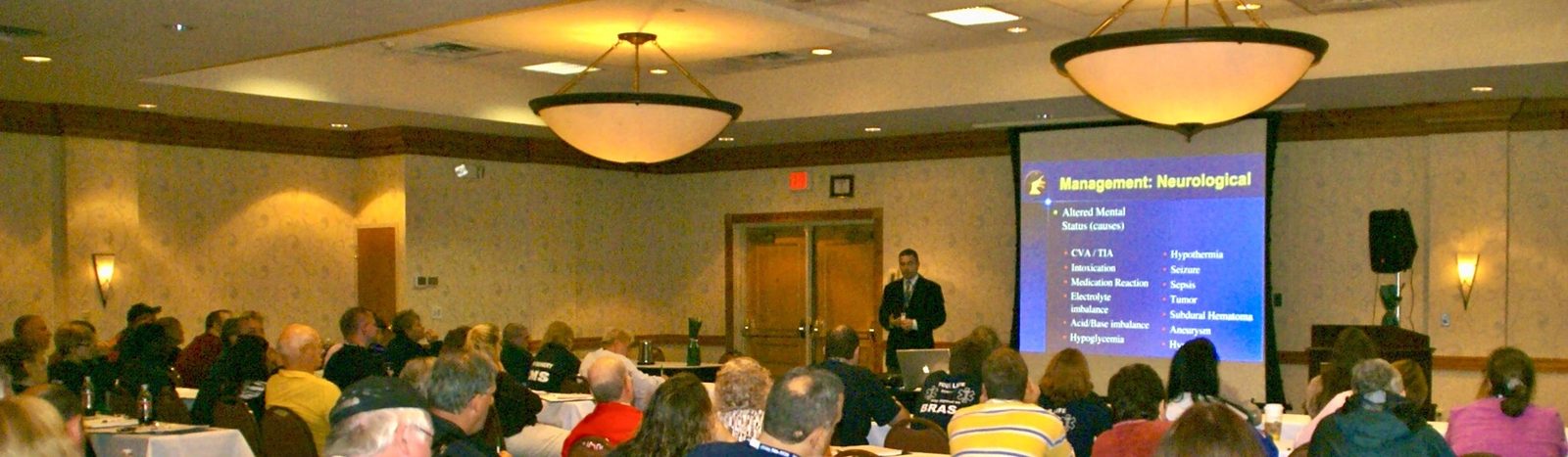 Rom Duckworth presenting to a full conference room.